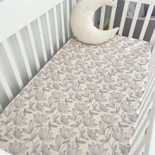 Load image into Gallery viewer, a white cot with a waterlily organic fitted cot sheet and a white moon pillow