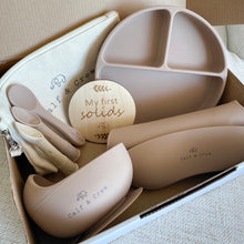 Load image into Gallery viewer, A box with a beige pouch, 3 spoons, a wooden plaque engraved with "my first solids", a silicone divided plate, sucion bowl and bib in latte colour