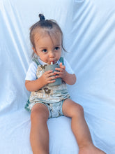 Load image into Gallery viewer, a child sitting drinking out of the silicone sippy cup in olive colour