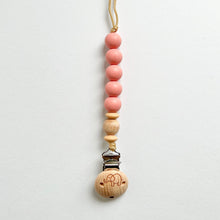 Load image into Gallery viewer, the silicone dummy clip in blush colour showing the elephant engraved wooden clip