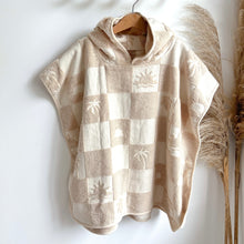 Load image into Gallery viewer, the hooded terry beach towel hanging on a wooden hanger