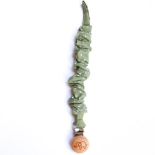 Load image into Gallery viewer, a cotton scrunch dummy clip in dottie sage colour with the elephant logo on the wooden clip