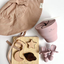 Load image into Gallery viewer, the floppy sun hat in rose colour with the wooden night sky puzzle, and a collapsible snack cup and easy grip spoon and fork in rose colour