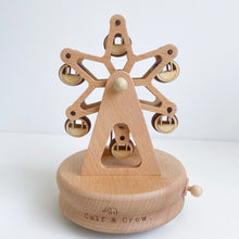 Load image into Gallery viewer, a wooden musical carousel with a spinning carousel and the calf & crew logo engraved at the bottom