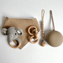 Load image into Gallery viewer, Chai coloured muslin bib with grey crochet elephant rattle, wooden silicone ring teether, silicone dummy clip in chai colour and soother case in latte colour