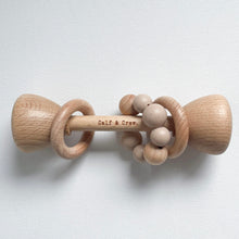 Load image into Gallery viewer, a wooden rattle with a chai silicone teether ring and the calf &amp; crew logo engraved on the center
