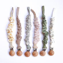 Load image into Gallery viewer, six cotton scrunch dummy clips in golden, dottie latte, ivy, gingham, dottie sage, and palm leaf