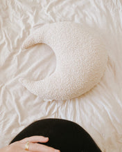 Load image into Gallery viewer, a hand on a pregnant belly leaning over a white boucle moon feeding pillow