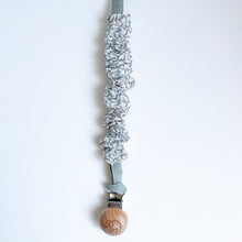 Load image into Gallery viewer, a cotton scrunch dummy clip in ivy colour with the elephant logo on the wooden clip