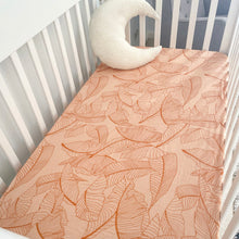 Load image into Gallery viewer, a white cot with a palm leaf organic fitted cot sheet and a white moon pillow