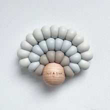 Load image into Gallery viewer, a silicone rainbow teether in sky blue colour showing the wooden ball with Calf & Crew logo