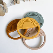 Load image into Gallery viewer, the silicone sunrise teethers stacked on each other in sunrise, sunset, dawn and stormy colours