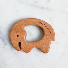 Load image into Gallery viewer, a wooden elephant teether with the calf & crew logo engraved on the edge