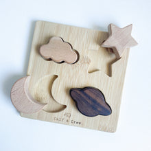 Load image into Gallery viewer, the wooden night sky puzzle with two pieces removed to show the spaces