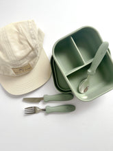 Load image into Gallery viewer, the crew cap in cream with an open silicone bento lunchbox in sage and stainless steel spoon, fork, and knife in sage colour