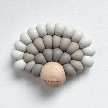 Load image into Gallery viewer, a silicone rainbow teether in dusk colour showing the wooden ball with Calf & Crew logo