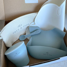 Load image into Gallery viewer, Box filled with Beige pouch with Calf & Crew logo, snack cup, silicone bib and spoon in baby blue colour, with white silicone placemat