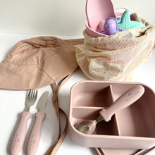 Load image into Gallery viewer, the floppy sun hat in rose next to the silicone beach toys in flamingo colour, with an opened silicone bento lunchbox in rose with a stainless steel spoon, fork and knife in rose