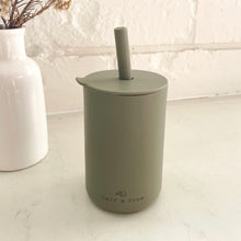 Load image into Gallery viewer, the silicone sippy cup in olive colour showing the calf & crew logo on the bottom of the cup