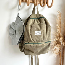Load image into Gallery viewer, a everyday sunhat in cloudy blue hanging on a wooden hook with a khaki coloured corduroy backpack