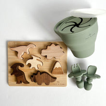 Load image into Gallery viewer, the wooden dinosaur puzzle with the collapsible snack cup and easy grip spoon and fork in sage colour