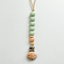 Load image into Gallery viewer, the silicone dummy clip in mint colour showing the elephant engraved wooden clip