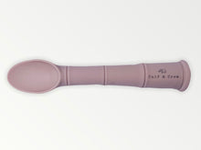 Load image into Gallery viewer, a my first baby spoon in rose silicone with the calf & crew logo