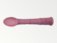 Load image into Gallery viewer, a my first baby spoon in dusty rose silicone with the calf & crew logo