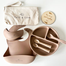 Load image into Gallery viewer, Beige pouch with Calf & Crew logo, a wooden plaque engraved with "my first solids", a suction bowl on a silicone bib, a divided plate with three spoons in latte colour