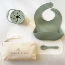 Load image into Gallery viewer, Beige pouch with Calf & Crew logo, snack cup, spoon and silicone bib in sage green colour on top of a white silicone mat