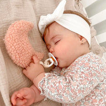 Load image into Gallery viewer, a baby sleeping with a baby pink teddy moon comfort dummy holder