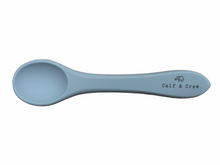 Load image into Gallery viewer, the silicone spoon in baby blue colour showing the Calf &amp; Crew logo on the handle
