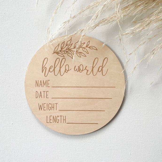 circle wooden disc engraved with hello world