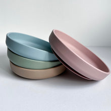 Load image into Gallery viewer, three silicon suction plates in baby blue, sage &amp; latte colour stacked with a rose silicone suction plate leaning on them
