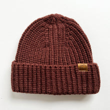 Load image into Gallery viewer, a chunky knit toddler beanie in chestnut colour with a leather calf &amp; crew logo
