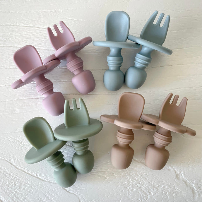 four sets of easy-grip spoon and forks in rose, baby blue, sage and latte