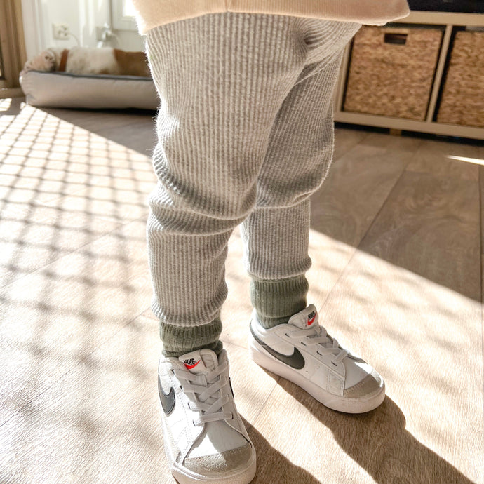 a child standing wearing the ribbed thick slim fit leggings in cloudy grey