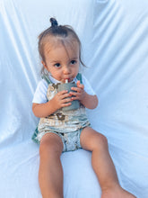 Load image into Gallery viewer, a child sitting drinking out of the silicone sippy cup in olive colour
