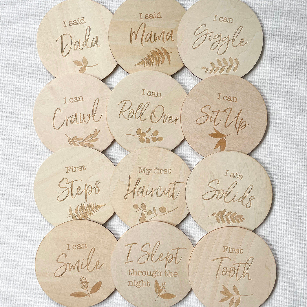 12 wooden discs engraved with different milestones