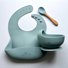 Load image into Gallery viewer, Silicone bib, silicone suction bowl, and a beechwood spoon in baby blue colour all with the Calf &amp; Crew logo
