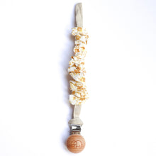 Load image into Gallery viewer, a cotton scrunch dummy clip in golden colour with the elephant logo on the wooden clip
