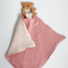 Load image into Gallery viewer, a wooden koala teether attached to a coral pink muslin comforter folded showing white underside
