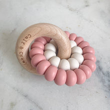 Load image into Gallery viewer, wooden ring with calf &amp; crew logo around a double silicone ring in blush colour
