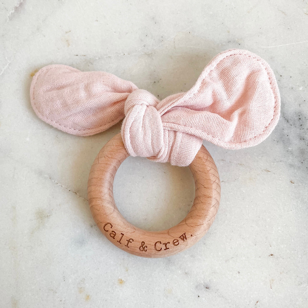Baby pink muslin bunny ear teether ring engraved with Calf & Crew logo