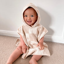 Load image into Gallery viewer, a smiling child wearing the hooded beach towel sitting on carpet
