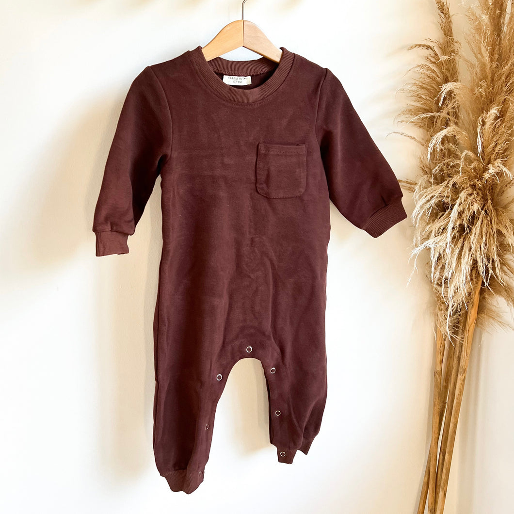 the kids tracksuit romper in coffee colour hanging on a wooden hanger