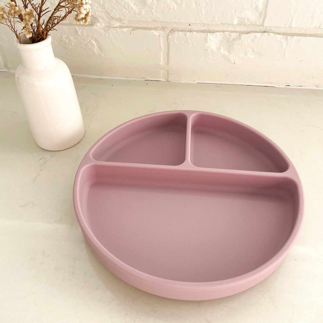 a rose coloured suction plate divided into 3 sections
