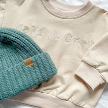Load image into Gallery viewer, the crew sweatshirt in eggnog colour under the toddler beanie in forest
