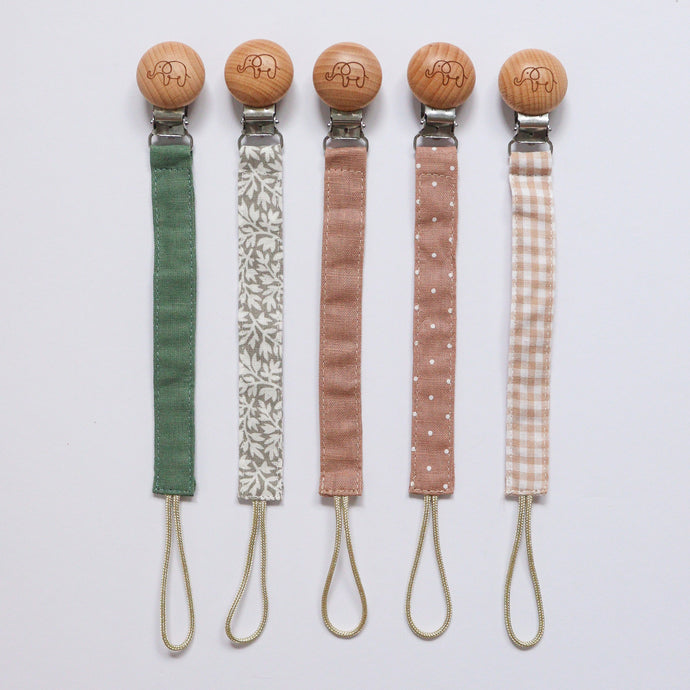 Five cotton dummy clips in different colours including pine, ivy, dusty rose, doty dusty rose, gingham