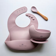Load image into Gallery viewer, Silicone bib, silicone suction bowl, and beechwood spoon in rose colour all with the Calf &amp; Crew logo
